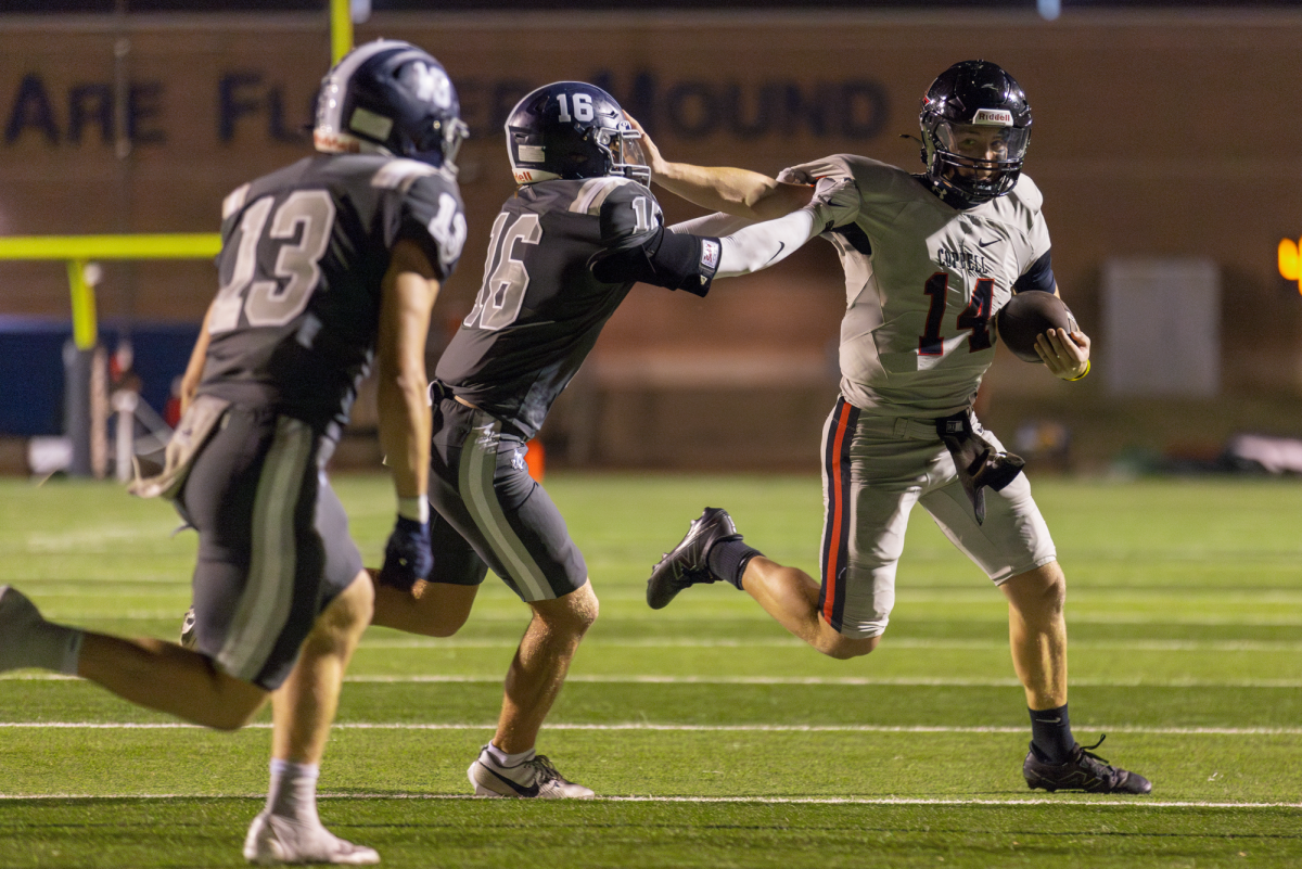 Coppell senior quarterback Edward Griffin stiff arms Flower Mound junior safety Corbin Ridenour on Friday at Neal E. Wilson Jaguar Stadium. The Cowboys defeated the Jaguars, 42-14.