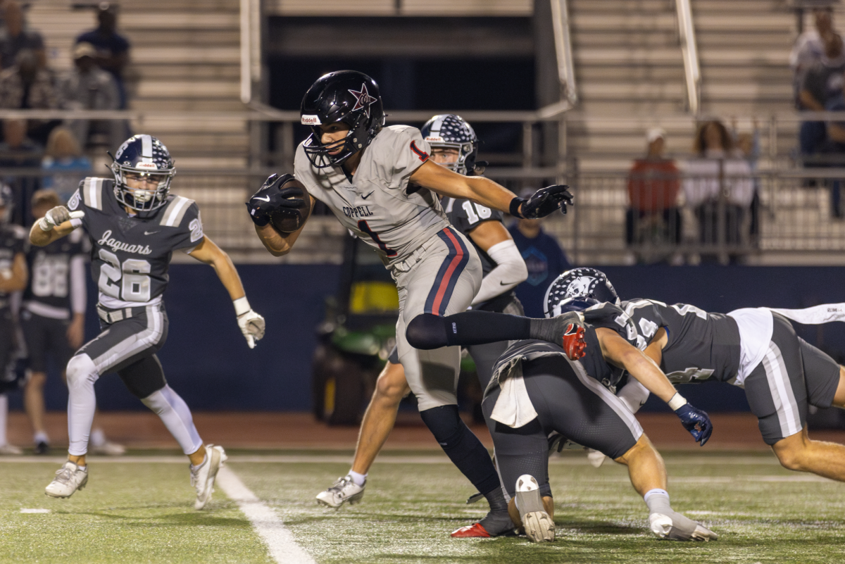 Coppell senior wide receiver Tucker Cusano breaks a tackle on Nov. 1 at Neal E. Wilson Jaguar Stadium. The Cowboys defeated the Jaguars, 42-14, securing their spot as District 5-6A champions. Photo by Kayla Nguyen.