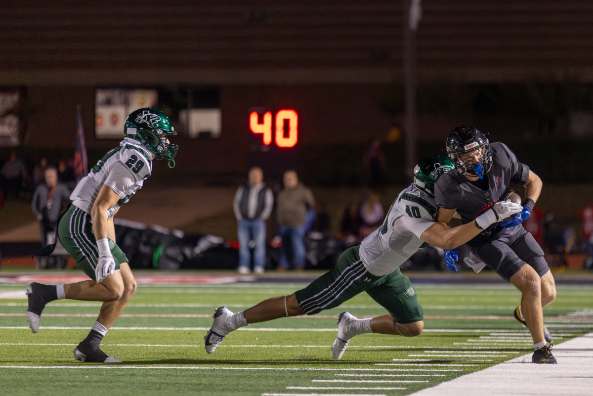 rosper junior linebacker Cade Smallwood tackles Coppell senior wide receiver Harry Hassmann on Nov. 15 at Buddy Echols Field. The Cowboys play Lake Highlands on Friday in the Class 6A Division I  Region I area playoffs. Photo by Kayla Nguyen.