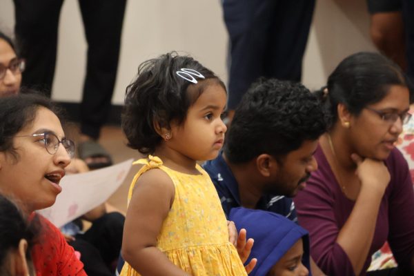 Coppell resident Mounika Lanka listens to a story at Diwali Family Fun Night on Oct. 29 at Cozby Library and Community Commons.  The event brought the community together at Cozby Library to celebrate Diwali with crafts, food and Diwali-themed activities. 