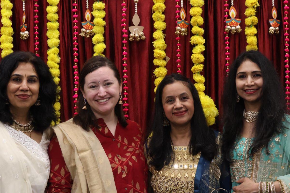 CHS9 special education aide Deepa Appachetolanda, librarian Brenna Conway, math teacher Gunjan Jain and instructional aide Rasmita Pydisetti take pictures in the library on Friday to celebrate Diwali. Diwali is the Hindu festival of light. Photo by Nyah Rama