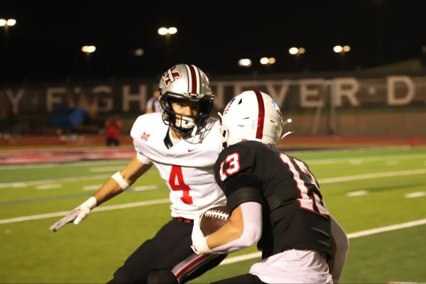 Coppell senior wide receiver Harry Hassmann evades Flower Mound Marcus junior defensive back Easton Mitchell on Nov. 7 at Buddy Echols Field. The Cowboys defeated the Marauders, 47-28, in their last regular season game, making program history as first time back-to-back 10-0 seasons. 