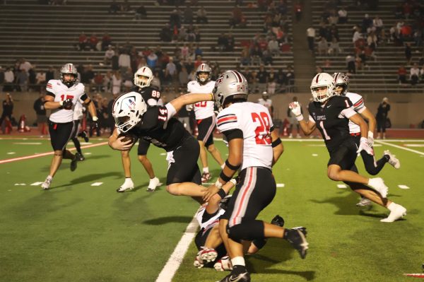 Coppell senior quarterback Edward Griffin evades Flower Mound Marcus junior linebacker Vincent Bui on Nov. 7 at Buddy Echols Field winning 47-28. The Cowboys play Prosper in the  Class 6A Division II Region I bi-district playoffs on Friday at Buddy Echols Field.