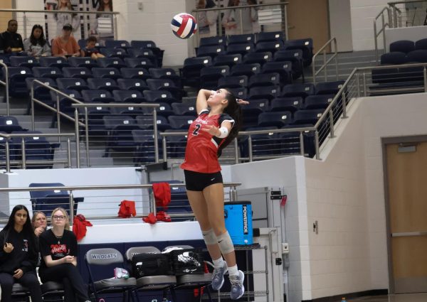 Coppell sophomore defensive specialist Hailey Chew serves against Allen on Tuesday at Walnut Grove High School Arena. The Cowgirls lost to the Eagles in the Class 6A Region I bi-district playoffs, 25-21, 25-15, 26-24. Photo by Vibha Viswanath