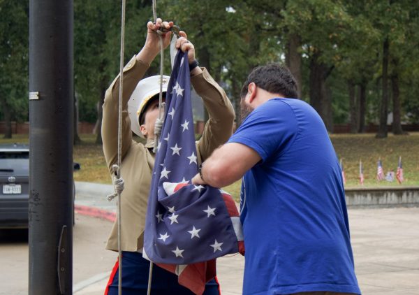 Coppell High School teacher and Marine Corps veteran Esther Gomez Splawn and New Tech High @ Coppell teacher and Army veteran Eric Splawn raise the American flag on Friday at CHS during the campus’s Veterans Day ceremony. Veterans, families and staff celebrated those who serve our country.