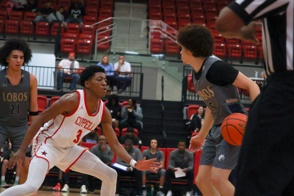 Coppell junior guard Sibu Socks defends Little Elm junior guard Ian Berry at CHS Arena on Tuesday. The Cowboys defeated the Lobos, 67-60, in the first District 5-6A game. Photo by Eirene Park.