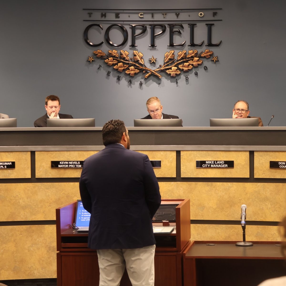 Coppell Council members Kevin Nevels and Mike Land and Mayor Wes Mays discuss and approve of the new construction of a new office building development next to Rolling Oaks cemetery on Nov. 12 at the council meeting in Town Center.