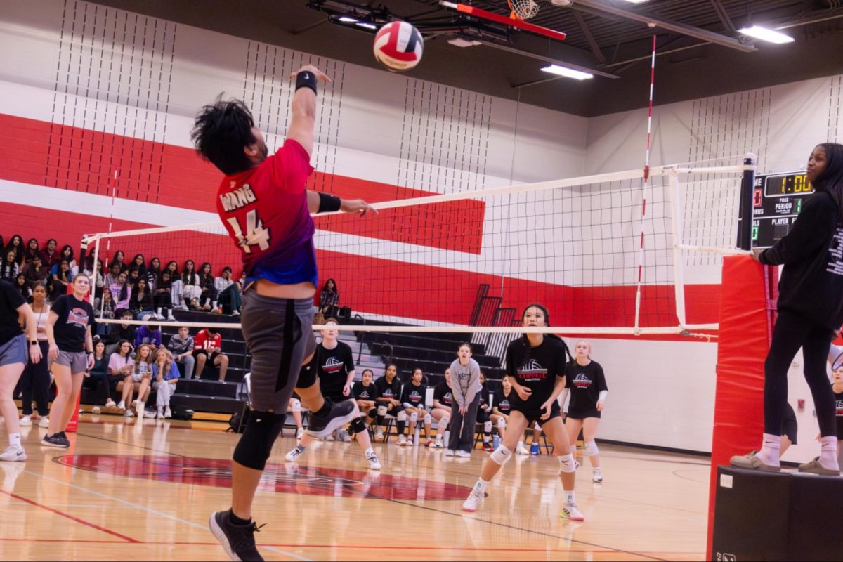 CHS9 math teacher Michael Wang spikes in the CHS9 Large Gym on Dec. 6. Annually, teachers and students compete in a volleyball game at CHS9. 