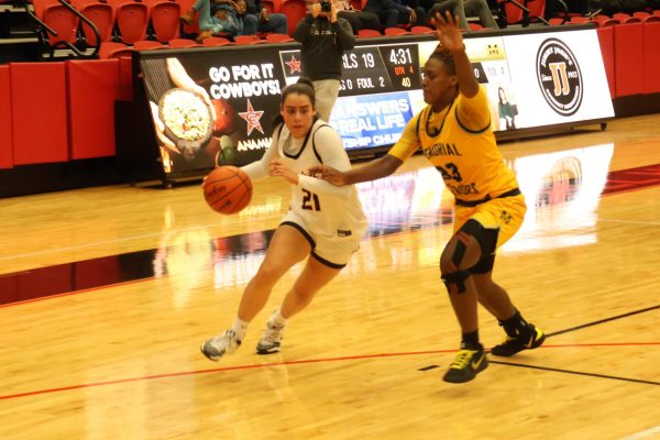 Coppell senior guard Sarah Mirza drives to the basket, beating Frisco Memorial freshman guard Sa'niyah Paulus off the dribble, for a layup. The Warriors defeated the Cowgirls 52-23.