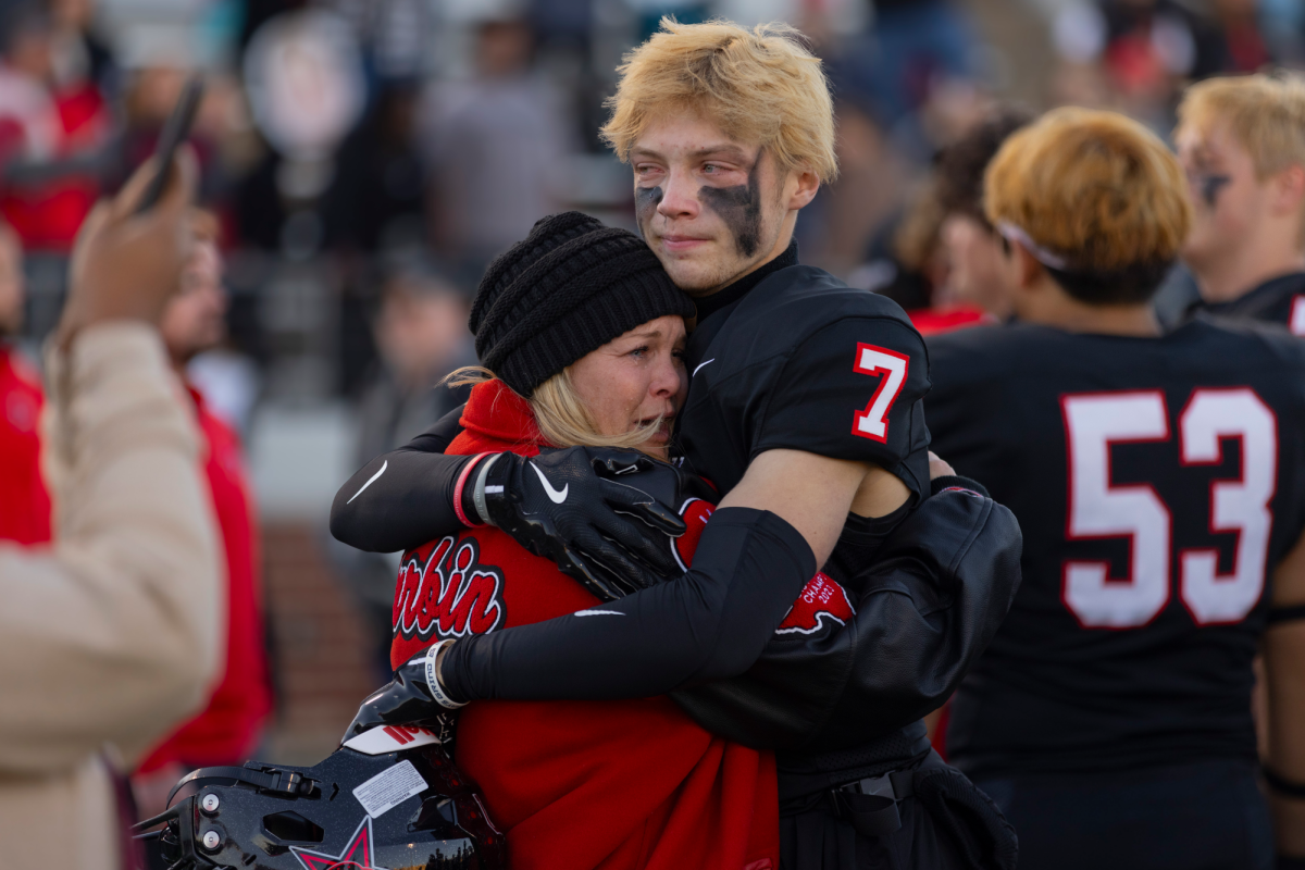 Coppell senior cornerback Zachary Durbin embraces his mother, Rachel Durbin, following a loss to North Crowley at Vernon Newsom Stadium on Saturday. The Panthers defeated the Cowboys, 35-24, in the Class 6A Division I Region I semifinals. Photo by Kayla Nguyen