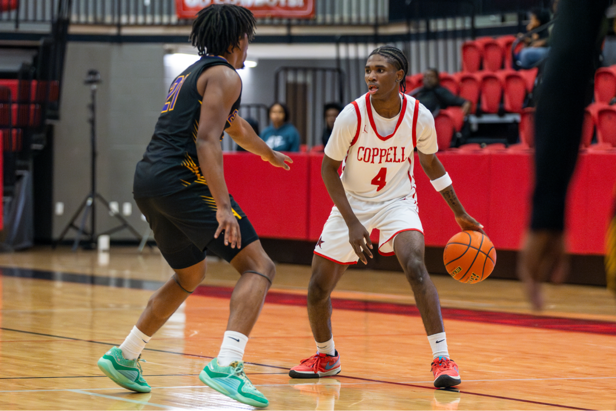 Richardson senior small forward Ashton Hawkins guards Coppell sophomore guard Robert Watson at CHS Arena on Tuesday. The Eagles defeated the Cowboys, 61-59. Photo by Kayla Nguyen