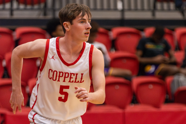 Coppell senior guard Drew Wagner hustles back on defense after a successful bucket by Coppell on Tuesday against Richardson on Tuesday at CHS Arena. Wagner’s adaptability and leadership has aided him in overcoming adversity throughout his basketball career. Photo by Kayla Nguyen