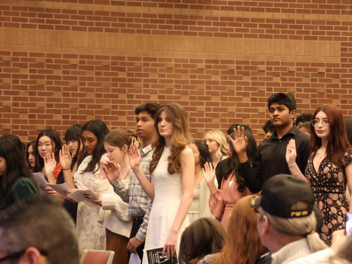 National Honor Society 2024-25 inductees take a pledge during the induction ceremony. Coppell High School students were inducted into NHS on Wednesday in the CHS Auditorium.