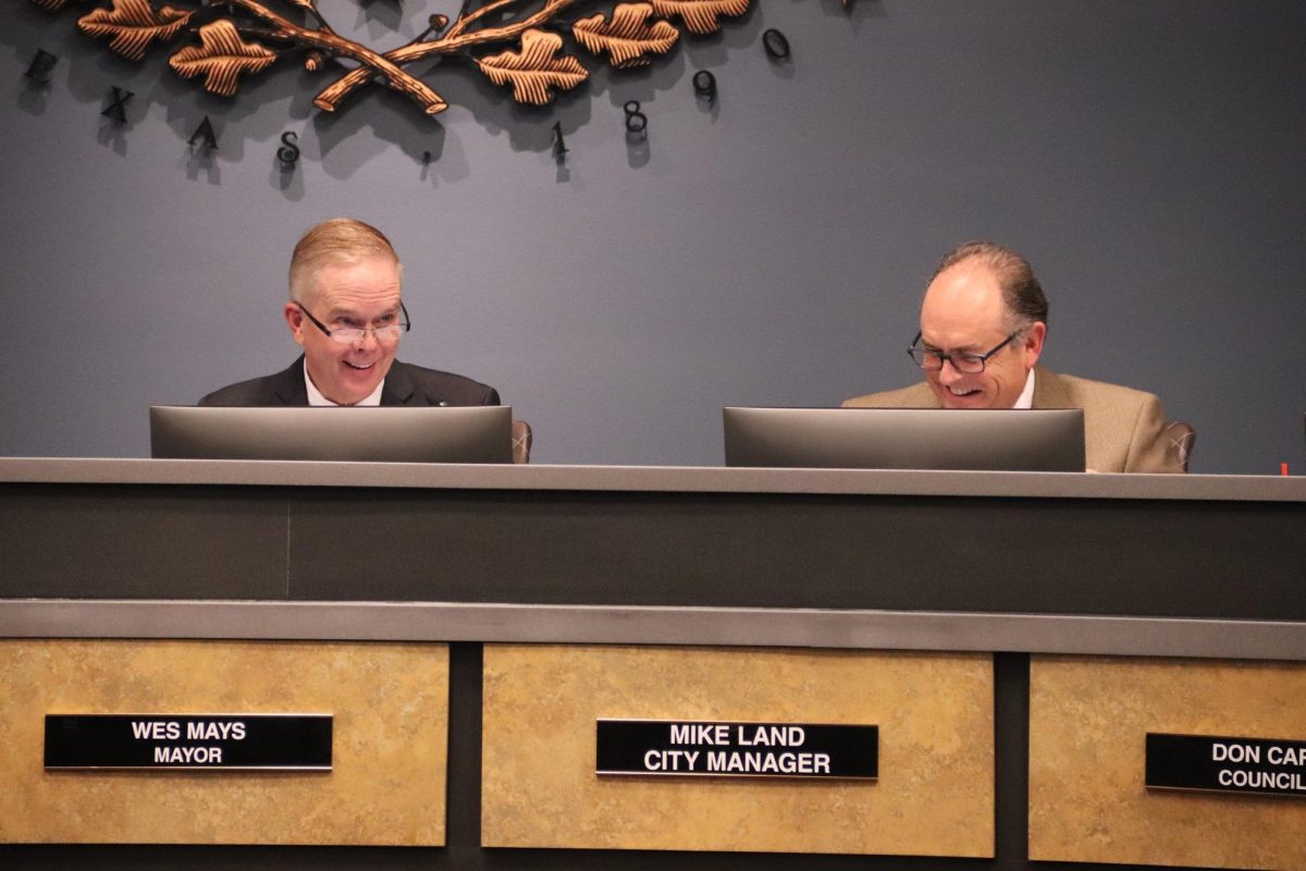 Coppell Mayor Wes Mays and city manager Mike Land discuss the motion of approving the plans for the construction of new Lake Breeze Condominiums on Tuesday night at the council meeting in Town Center. 