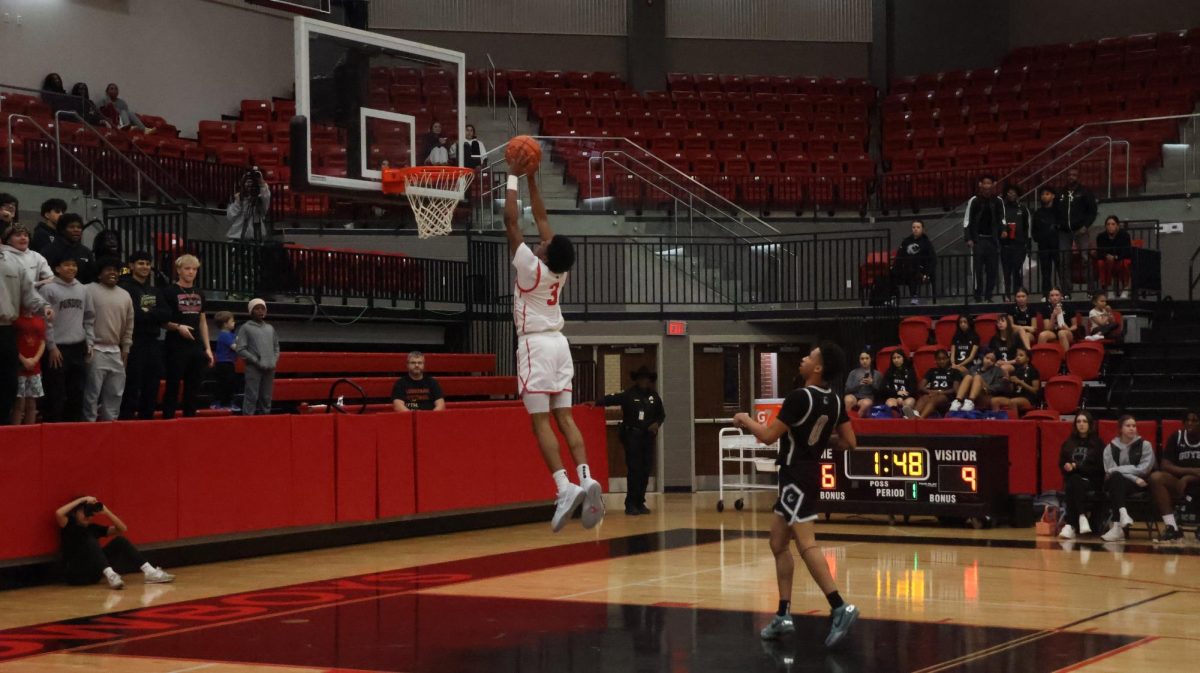 Coppell junior forward Sibu Ncube-Socks dunks against Guyer at CHS Arena on Friday. The Wildcats defeated the Cowboys, 56-44. 