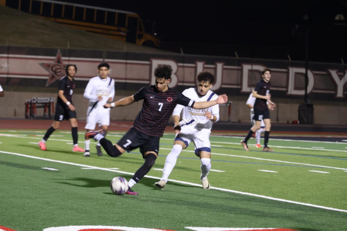 Coppell senior captain Luis Mendez Gil and Little Elm midfielder Santiago Grinstaff fight for possession at Buddy Echols Field on Tuesday. Coppell defeated Little Elm, 2-1. Photo by Karen Mascarenhas
