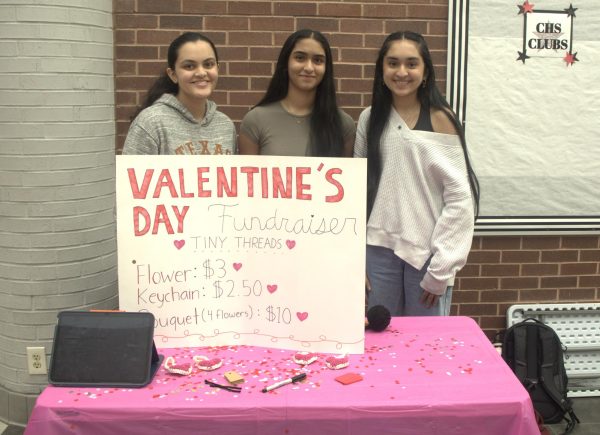 Coppell High School Tiny Threads Crochet Club senior president Arya Adhikary, sophomore secretary Sahasra Veerapaneni and sophomore vice president Diya Gandhi sell crochet items in the Commons on Feb. 13. The Tiny Threads club teaches members how to crochet and create items to donate to those in need. Photo by Hiral Patel