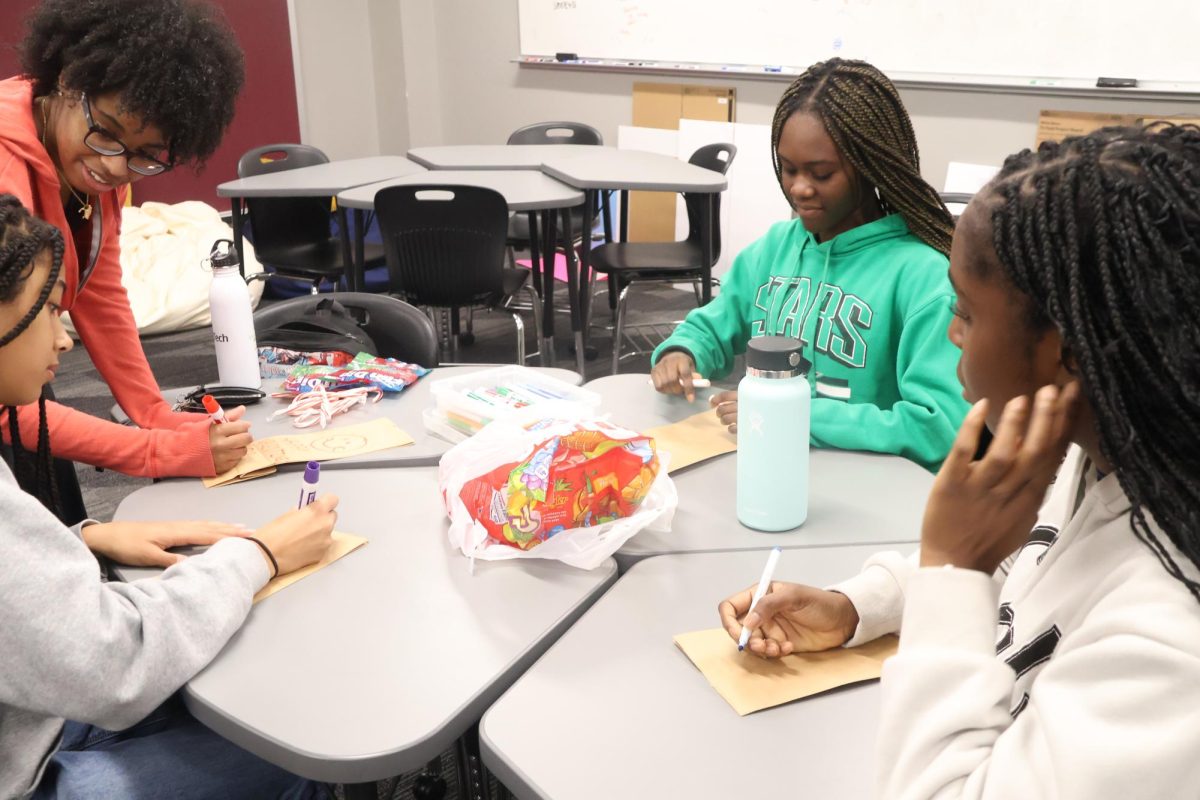 Coppell High School Black Student Union members Alana Nixon, KeTurah Richey, Sweetie Ansah and Kamsi Mbanugo create Valentine’s Day bags to help strengthen bonds among their members. BSU’s daily announcements throughout Black History Month in February highlight the contributions of Black historical figures in shaping society. Photo by Yoshita Sanivarpu.