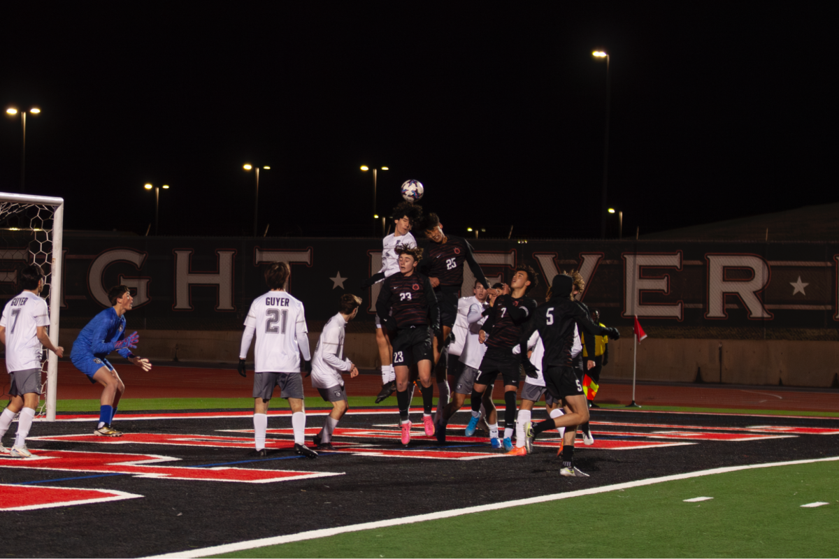 Coppell junior defender Luke Brinck and Denton Guyer senior defender Andrew Yates jump for a header on Feb. 21 at Buddy Echols Field. The Cowboys play Flower Mound on Friday at Buddy Echols Field. Photo by Sabah Uddin.
