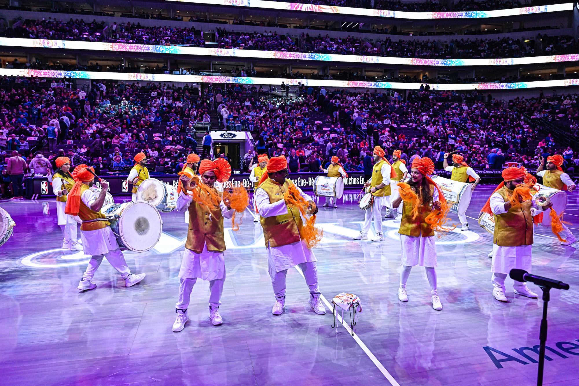 Coppell High School senior Rohak Yadav [second from left] performs with Indian ethnic music group Shivam Dhol Tasha during the Dallas Mavericks halftime show at American Airlines Center on March 9. Yadav has played the tasha, an Indian percussion instrument, since he was 6 and joined Shivam Dhol Tasha in 2024. Photo courtesy Roberto Hernandez/Dallas Mavericks 