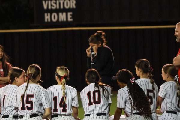 Coppell softball coach Emily Witt addresses her team following its final home game of the season at CISD Baseball/Softball Complex on Tuesday. The Cowgirls lost, 7-0. To Flower Mound in District 5-6A play.