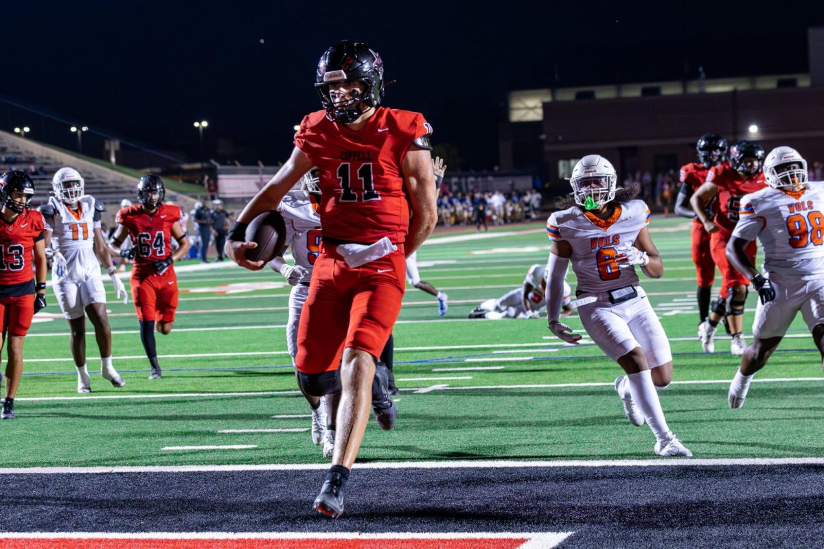 Coppell sophomore quarterback Carter Zingelmann scores a 23-yard touchdown against Arlington Bowie at Buddy Echols Field on Friday. The Cowboys beat the Volunteers, 47-26. Photo by Naila Ali