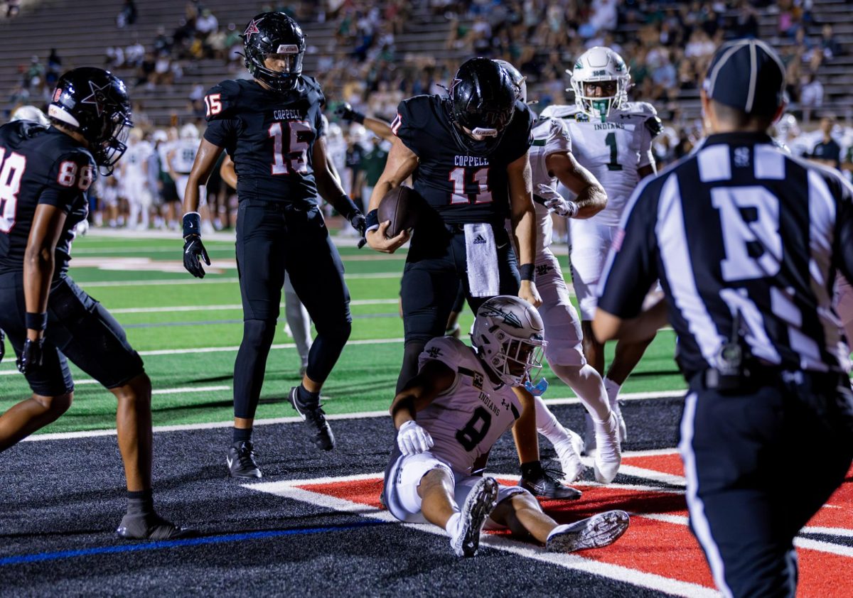 Sophomore quarterback Carter Zingelmann celebrates a touchdown against Waxahachie at Buddy Echols Field last Friday. Coppell plays Arlington Bowie at Buddy Echols Field at 7 p.m. Friday. Photo by Naila Ali