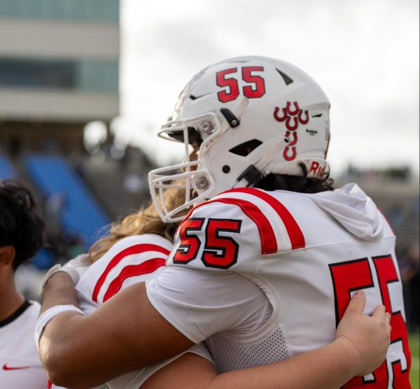 Coppell senior offensive lineman Cooper Williams and junior lineman Eric Anguiano embrace after the game against North Crowley on Saturday at Midlothian Multi-Purpose Stadium. The Cowboys fell to the Panthers, 46 - 21. Photo by Naila Ali