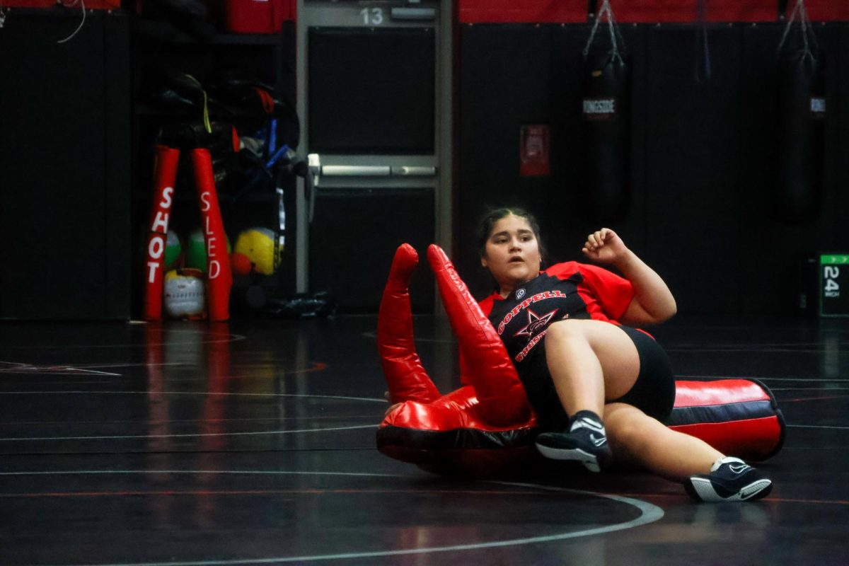 Coppell senior Laura Lucio practices with a wrestling dummy on Nov. 20 at CHS Indoor Facility. The wrestling team hosted the Coppell Round-Up, competing against 16 teams.