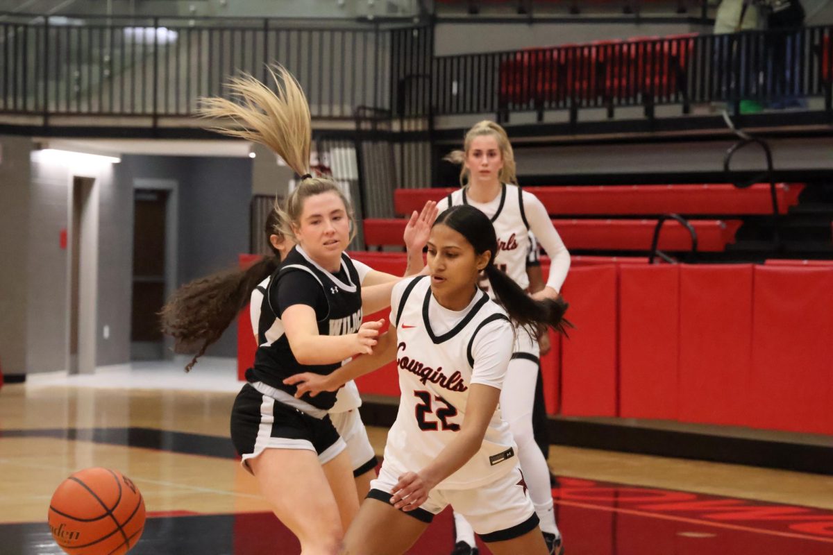 Coppell senior guard Nihira Nadgonde runs past Guyer defense on Dec. 16 at the CHS arena. The Coppell Cowgirls defeated the Guyer Lady Wildcats, 54-51.
