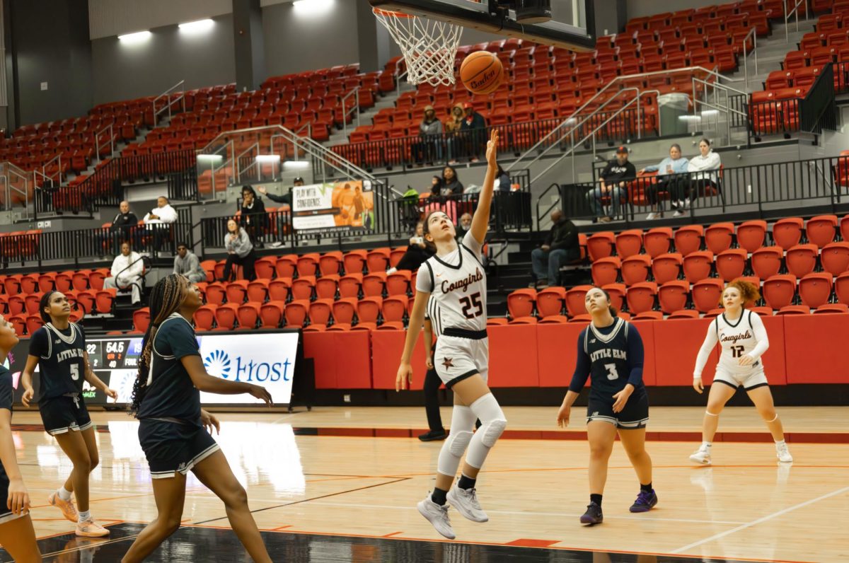 Coppell High School sophomore guard Amber Coffey scores a layup against Little Elm on Thursday at CHS Arena. The Cowgirls defeated the Lady Lobos, 44-31, in District 5-6A action. 
