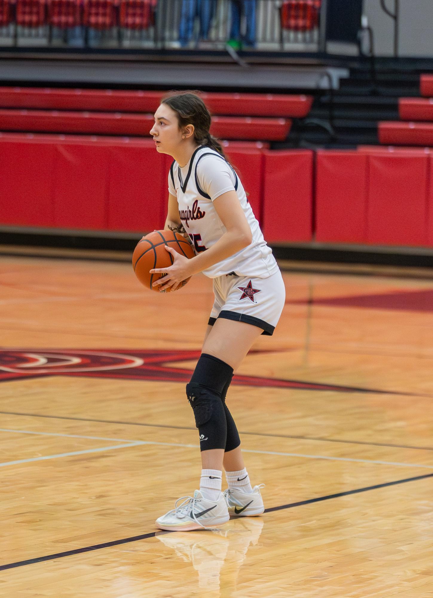 Coppell sophomore point guard Avary Campbell passes to her teammate on Dec. 16 at CHS Arena. Campbell honors her late brother Jaxon Campbell’s legacy by playing basketball for him. 