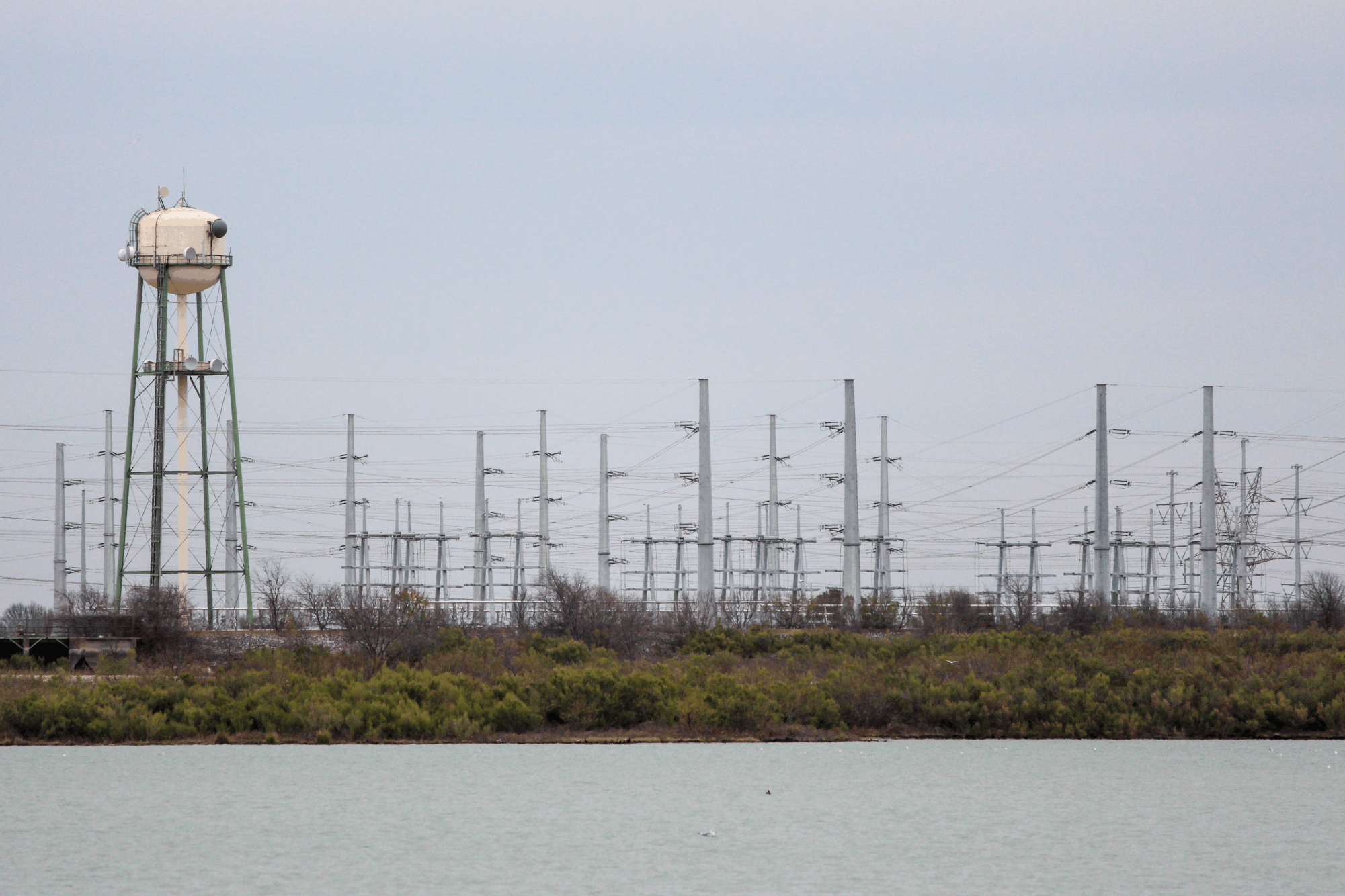 An Oncor substation is visible across North Lake from Cypress Waters, next to a water tower where a former power plant operated. North Lake and the bordering Cypress Waters development carry a complex history involving construction and controversy.
