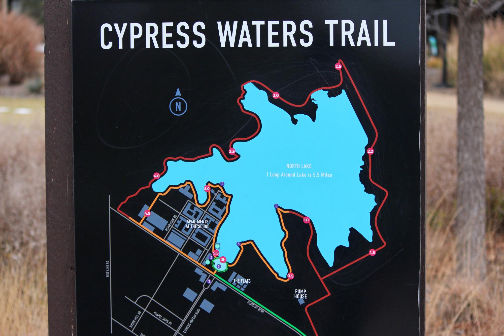 A board at The Sound shows the path of Cypress Waters trail around North Lake. North Lake and the bordering Cypress Waters development carry a complex history involving construction and controversy. 