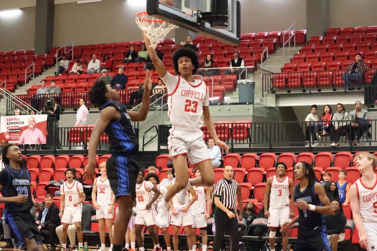 Coppell junior guard Iorna Handem dunks against Hebron on Tuesday at the CHS Arena. The Cowboys defeated the Hawks 67-39. 