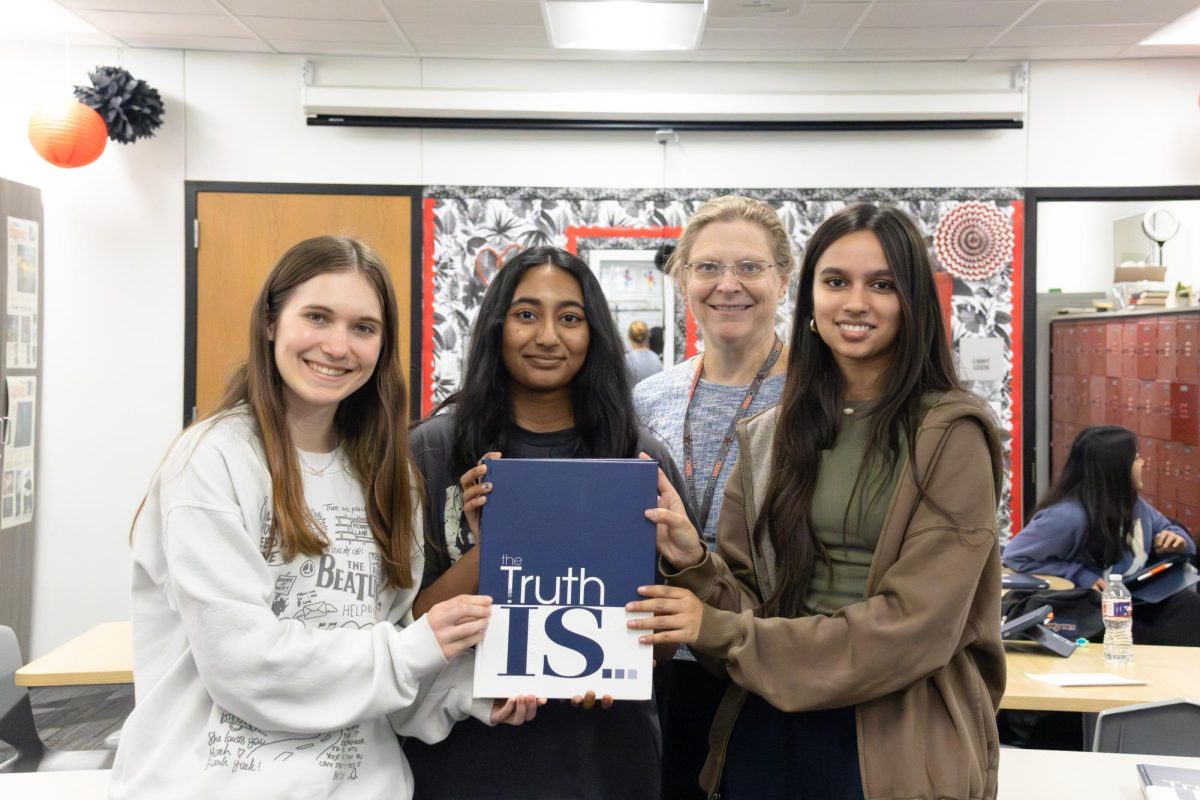 Round-Up editor-in-chiefs Alyssa Gray, Samanvi Sadak, adviser Katrina Hester and managing editor Arshia Joshi showcase the Round-Up yearbook eligible for a 2026 National Scholastic Press Association Pacemaker. Round-Up was named an NSPA Pacemaker finalist On Dec. 18, marking a historic first for the program. 