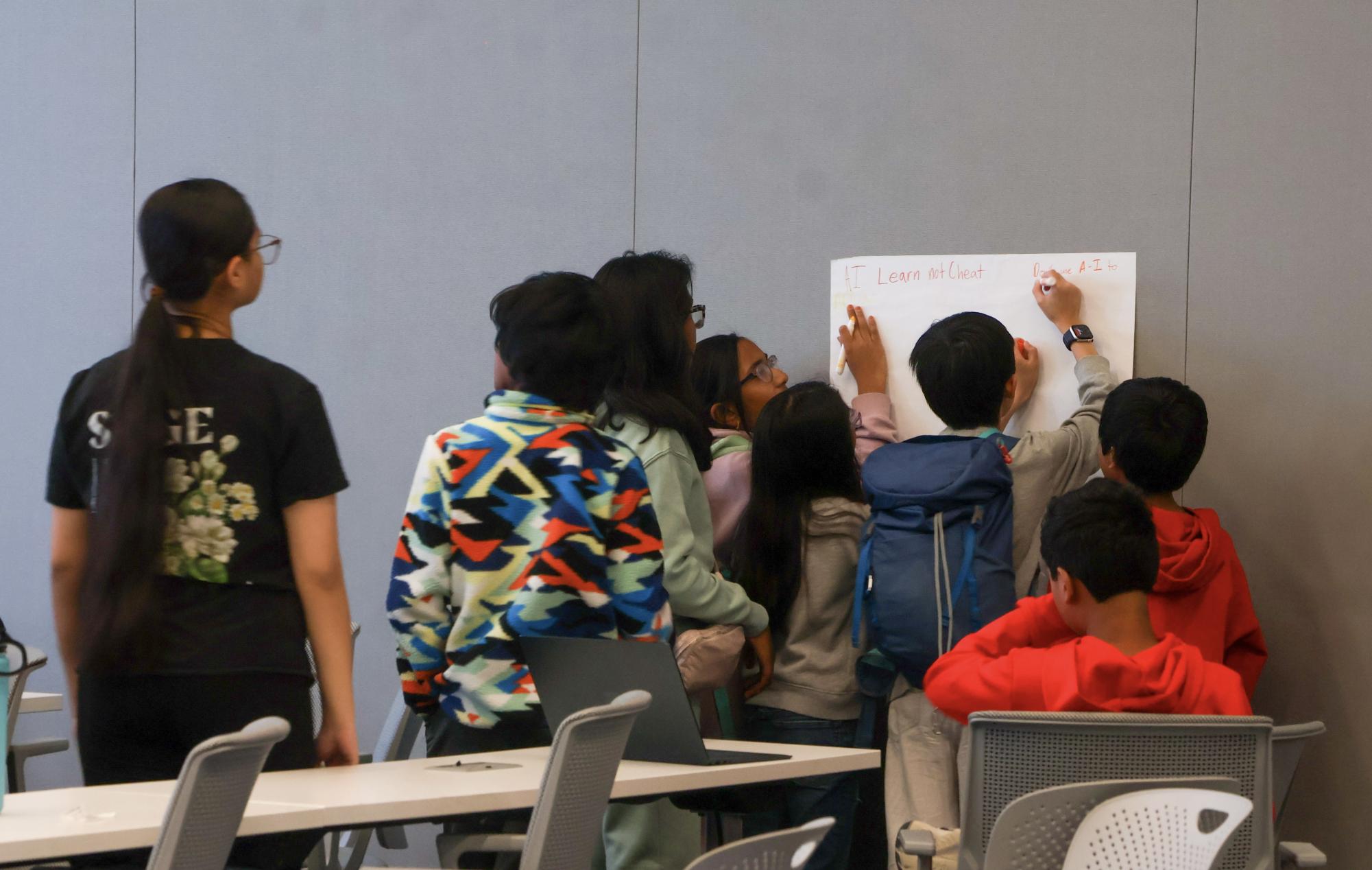SAGE’s artificial intelligence seminar hosts an activity where kids create posters about how AI can be used for learning on Dec. 16 at Nokia in Cypress Waters. SAGE collaborated with Nokia for an AI seminar and activity tour.