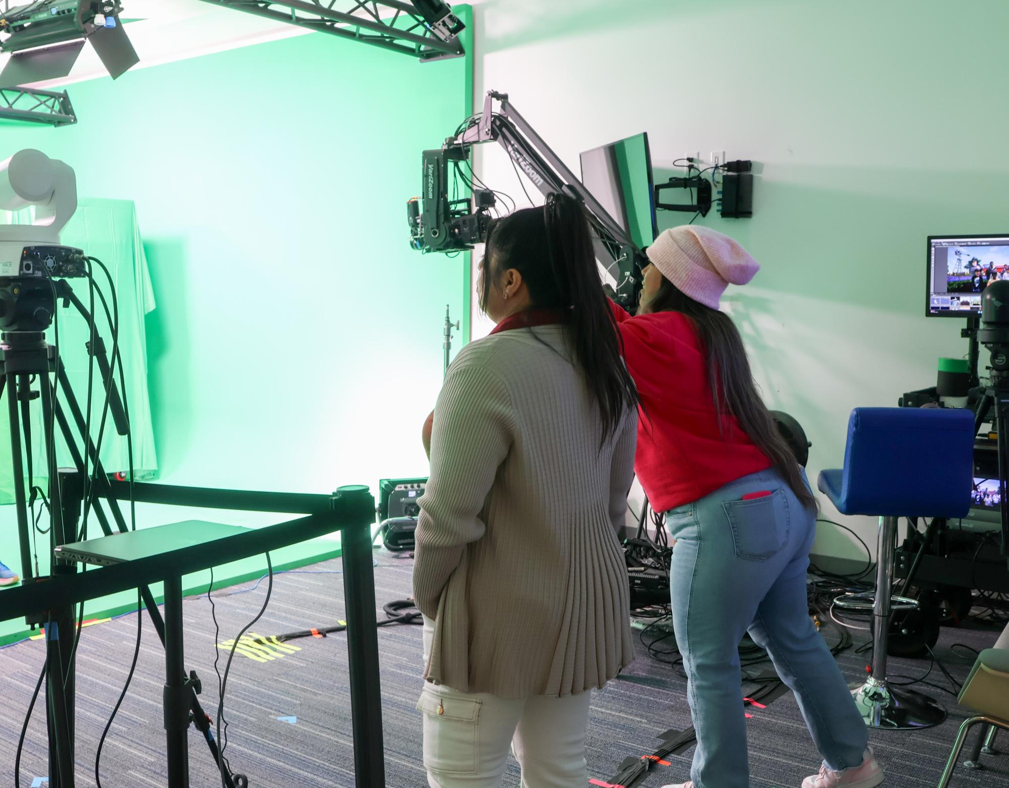 Nokia staff members Izzy Johnson and Vickie Guerrero lead an interactive demonstration of the Nokia’s green room works, allowing SAGE participants to take photos behind a green screen on Dec. 16 at Nokia in Cypress Waters. SAGE collaborated with Nokia for an artificial intelligence seminar and activity tour.