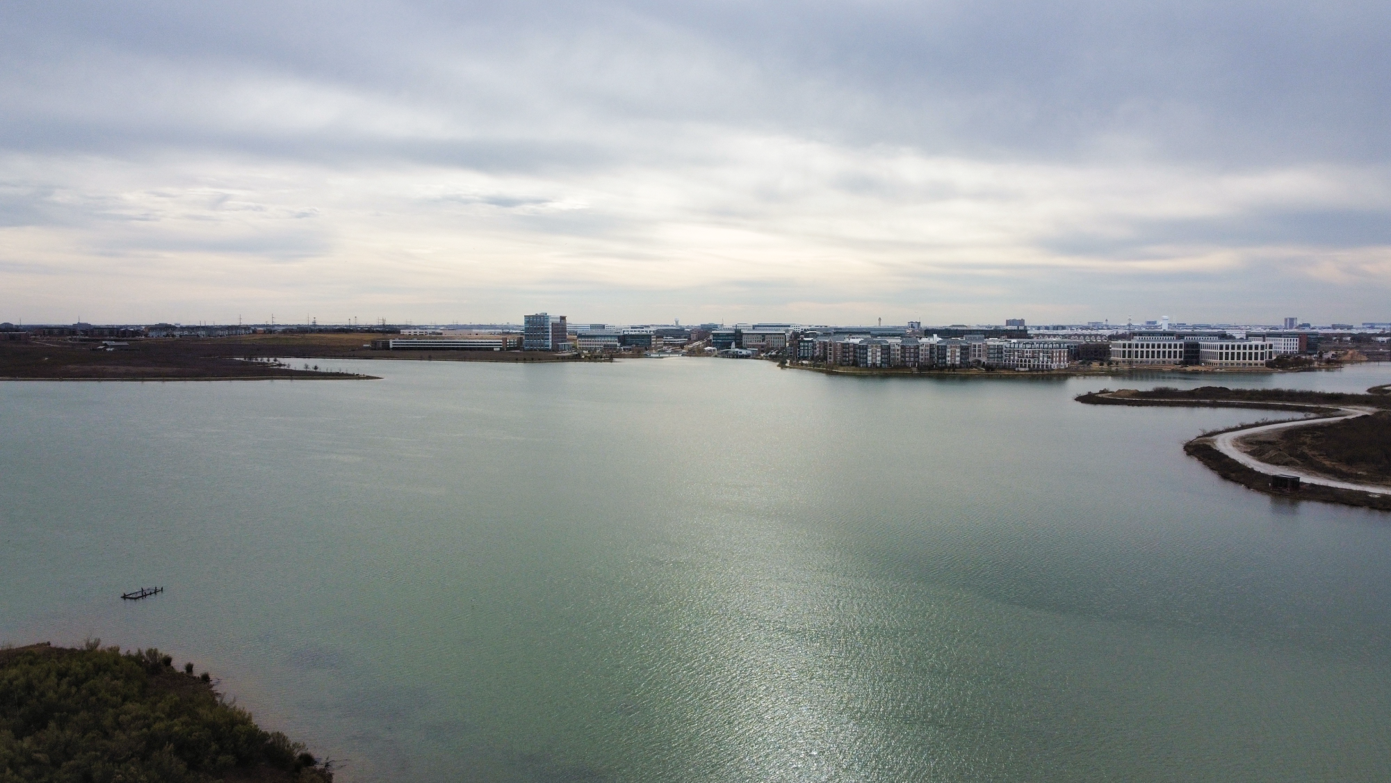 Apartment communities and The Sound in Cypress Waters can be seen overlooking the southern shore of North Lake. North Lake and the bordering Cypress Waters development carry a complex history involving construction and controversy.