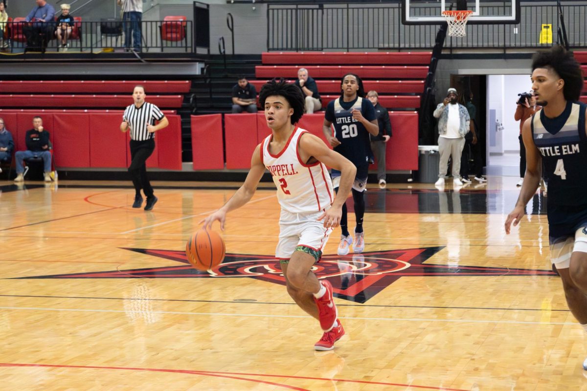 Coppell High School senior guard Isaiah Fleming dribbles against Little Elm on Thursday at CHS Arena. The Cowboys lost to the Lobos, 73-67.