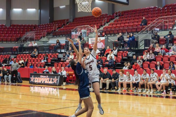 Coppell junior point guard Prisha Kolhe scores a layup against Little Elm on Jan. 29 at CHS Arena. The Cowgirls defeated the Lady Lobos, 44-31, in District 5-6A.
