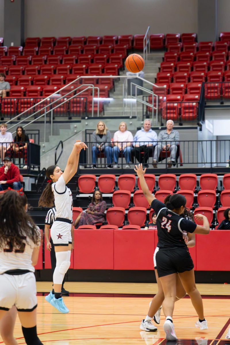Coppell sophomore guard Amber Coffey scores a 3-pointer against Flower Mound Marcus on Tuesday in the CHS Arena. The Marauders defeated the Cowgirls, 57-35. 