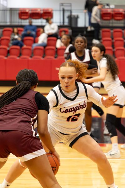 Coppell High School senior forward Mallory Cooper defends against Lewisville on January 8 in the CHS Arena. The Cowgirls open the Class 6A Region I bi-district playoffs on Feb. 17 against Allen at Carrollton Creekview. 
