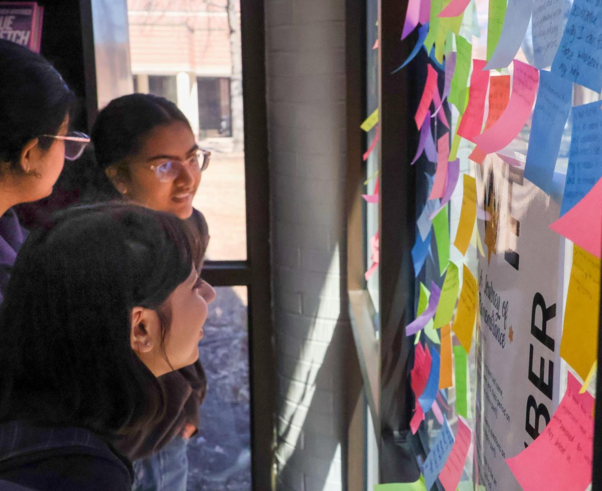 Coppell High School seniors Prerita Singh, Shriti Sinha and junior Aliza Azam observe the responses of fellow students about the importance of the Holocaust in the CHS Library during AP Macroeconomics Dani Roseberry's sixth period class on Thursday. The Holocaust awareness sessions were organized to learn and remember the harsh realities that occurred.