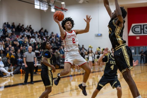 Coppell senior point guard Isaiah Flemming scores a lay up against Plano East on Monday at Creekview High School. The Cowboys defeated the Panthers, 69-56 in 5-6A bi-district playoffs . Photo by Naila Ali