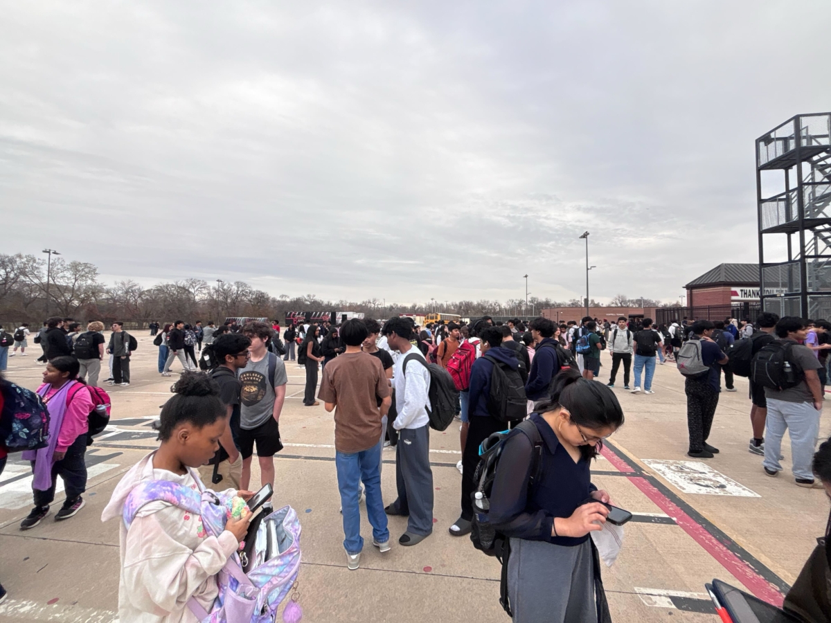 Coppell High School students and faculty on Wednesday morning near the fine arts building and Buddy Echols Field, waiting for further instructions from Principal Laura Springer. CHS students and staff evacuated around 8:20 a.m. due to a bomb threat. As a result, students who did not drive themselves to school were transported to CHS9 for parent pickup as school was released for the day.
