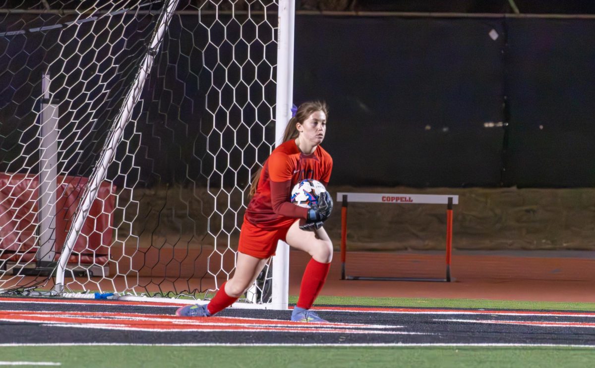 Coppell senior goalkeeper Kelsey Clark saves a shot against Hebron on Jan. 20 at Buddy Echols Field. Clark’s commitment to soccer ever since she was little has built a foundation for her future. Photo by Karen Mascarenhas 