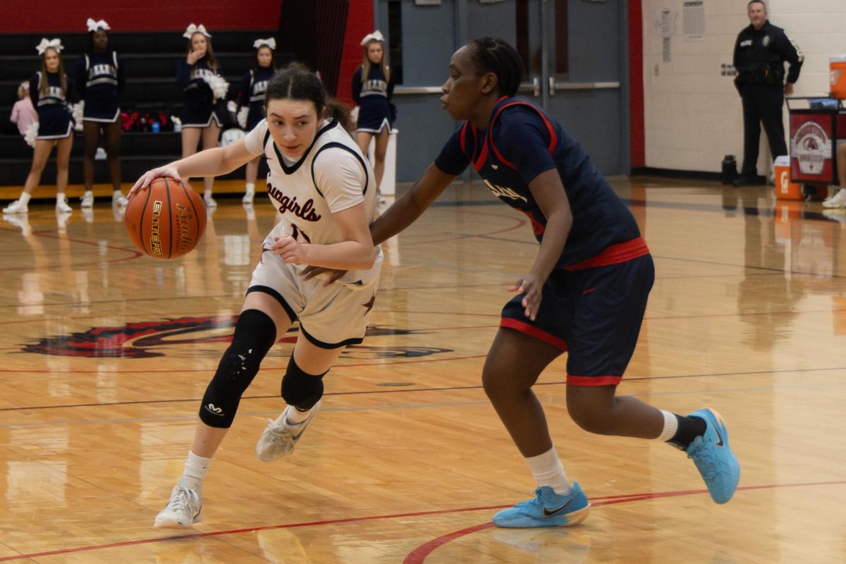 Coppell sophomore point guard Avary Campbell powers down court against Allen senior guard Zaria Kyalo at Creekview on Feb. 17. The Eagles defeated the Cowgirls, 40-35.