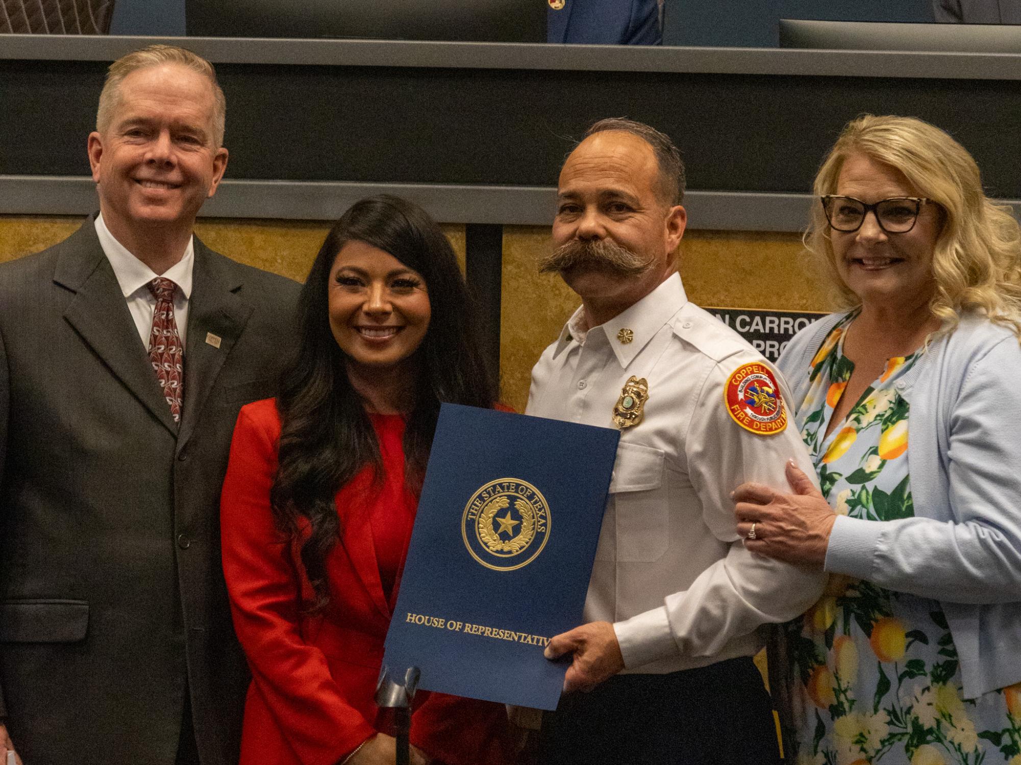 Coppell Mayor Wes Mays and Texas State Representative Cassandra Garcia Hernandez present Fire Chief Kevin Richardson and his wife, Karla, with a plaque to honor his upcoming retirement on Feb. 10 at Coppell City Hall. After serving as the Coppell Fire Department’s Chief for two decades, Richardson’s last day is Friday.