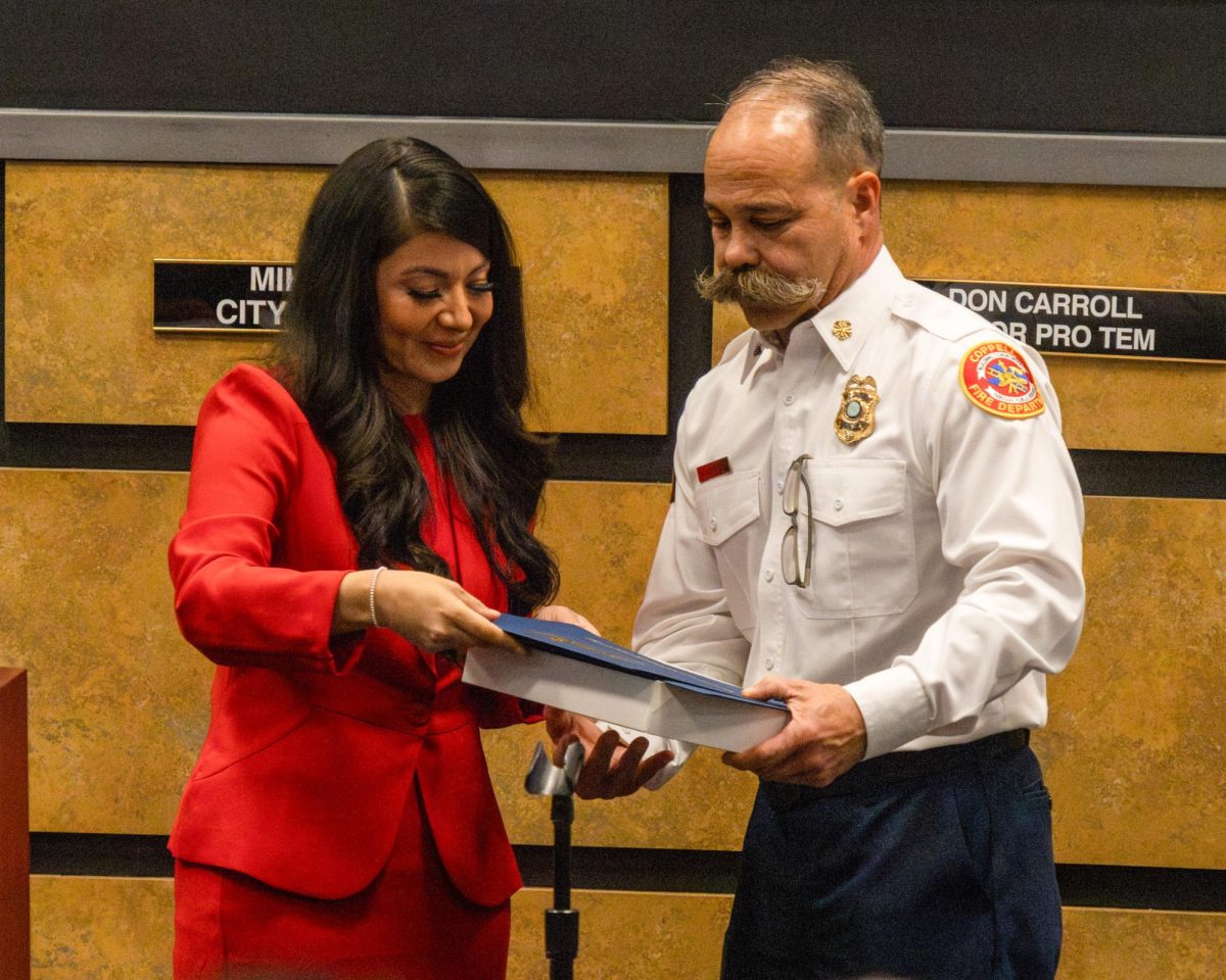 Texas State Representative Cassandra Garcia Hernandez presents Fire Chief Kevin Richardson with a plaque to honor his retirement on Feb. 10 at Coppell City Hall. After serving as the Coppell Fire Department’s Chief for two decades, Richardson’s last day is Friday. 